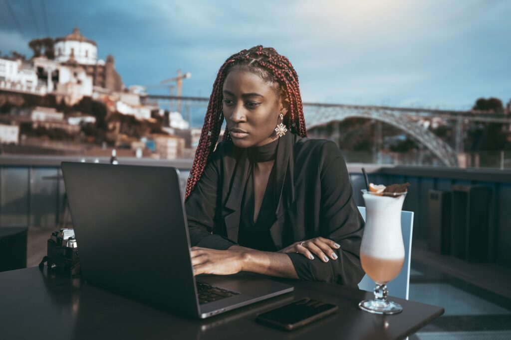 African lady using a laptop outdoors